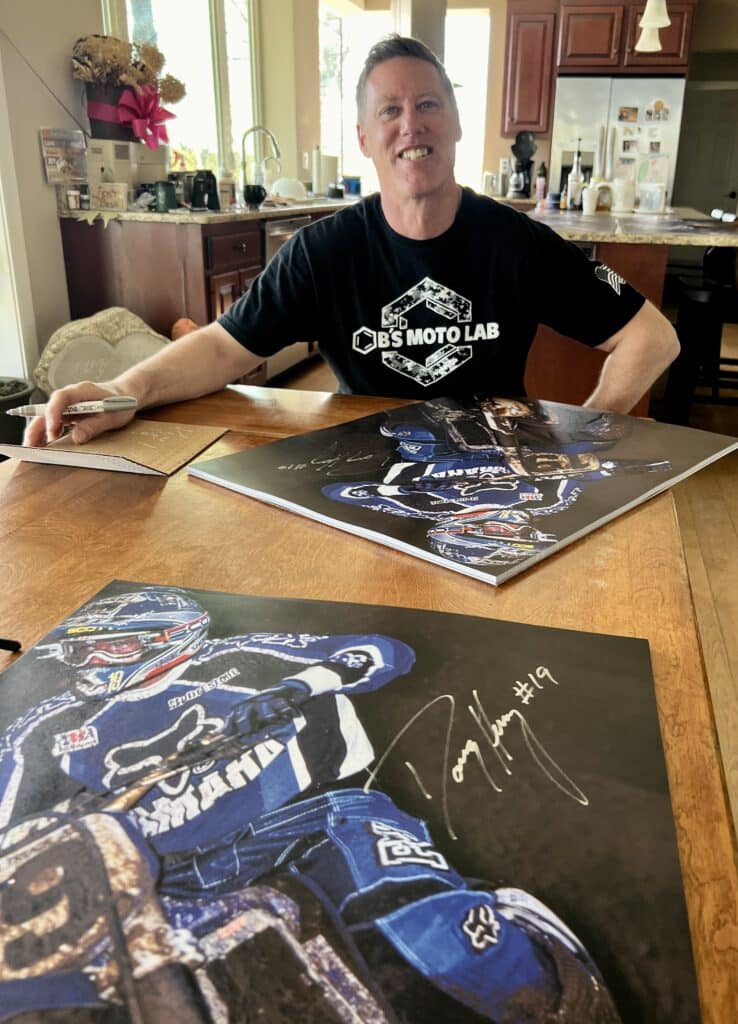 Doug Henry signing Southwick 1998 prints in his dining room.